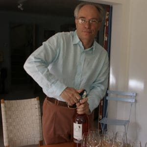 David Way opening a bottle of wine